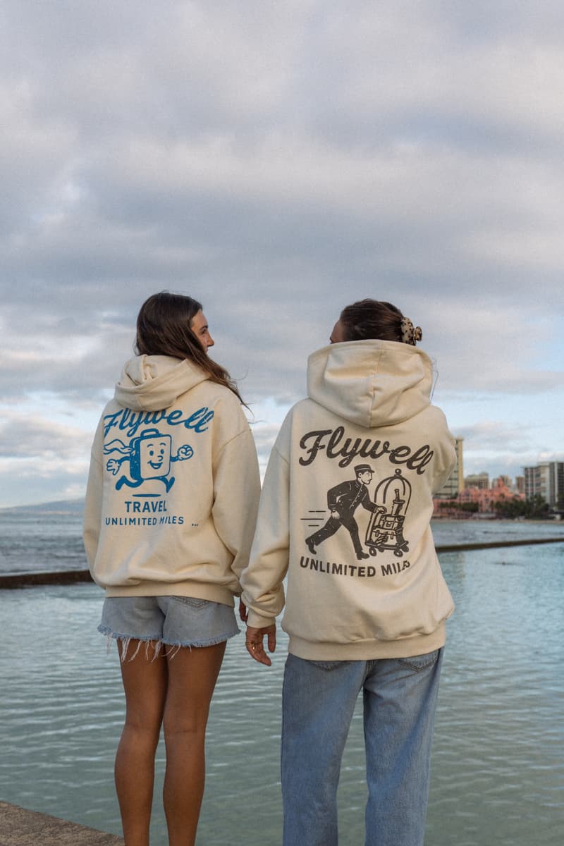 The girls wearing Mr Suitcase and The Bellhop hoodies by the ocean