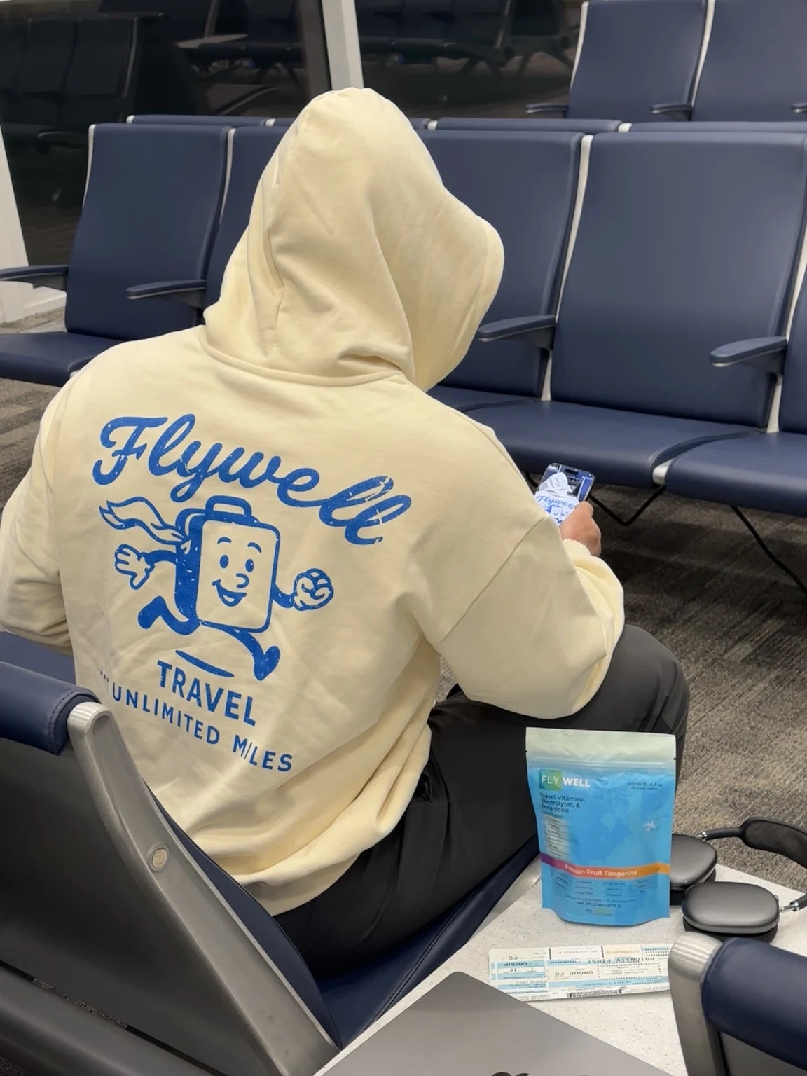 Mr Suitcase hoodie and FlyWell pouch at the airport gate
